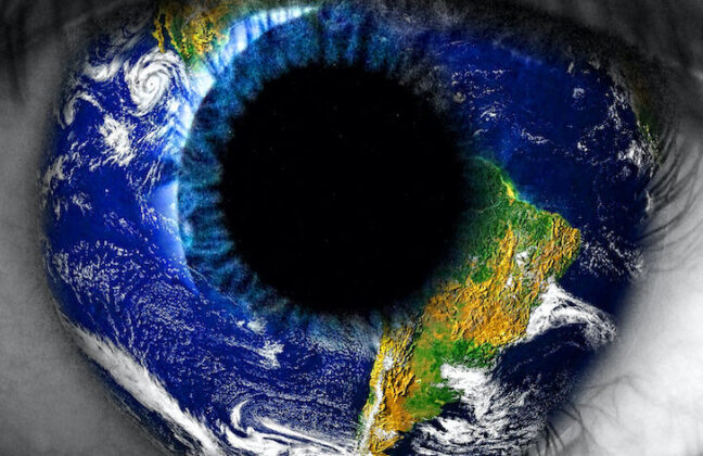Close up of black and white eye, iris is a coloured photograph of the Earth