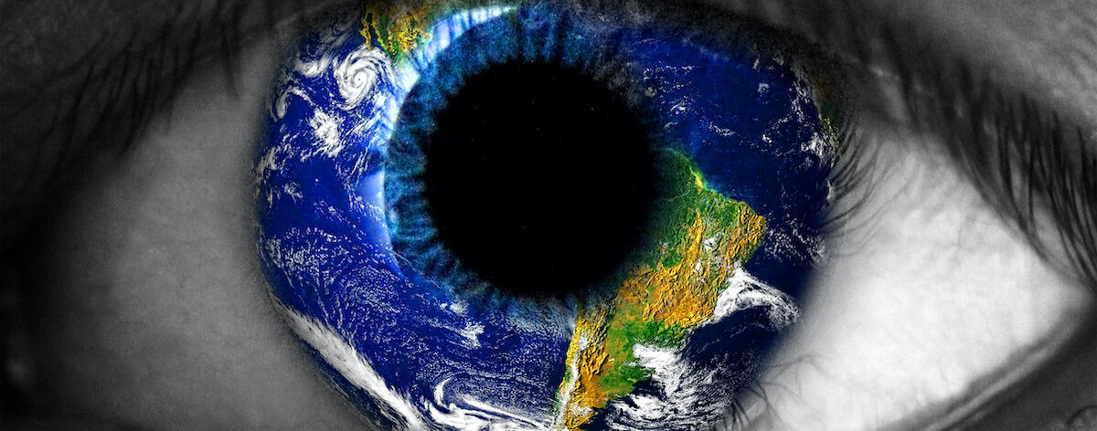 Close up of black and white eye, iris is a coloured photograph of the Earth